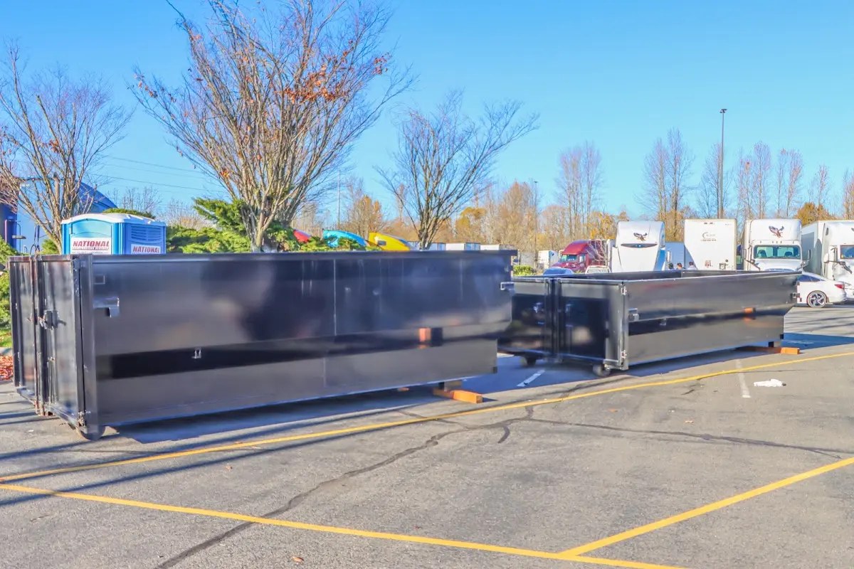 Professional dumpster rental service with roll-off container on residential driveway in Lochearn